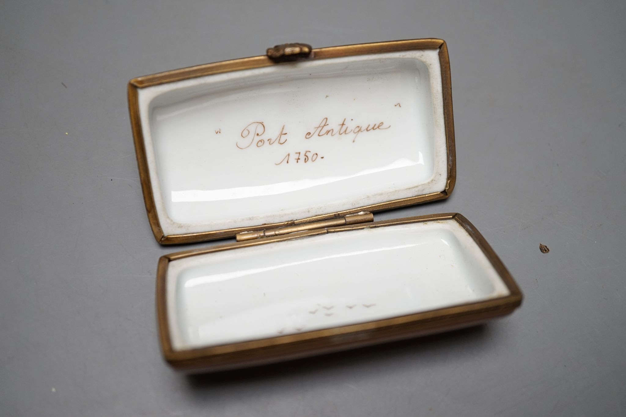 A Russian oval lacquered box, 10cm., and a porcelain box painted with ships approaching harbour
